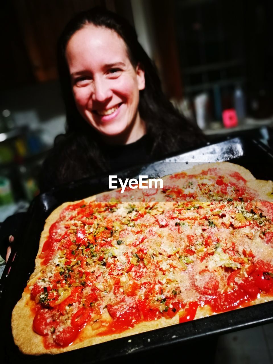 Portrait of smiling woman having pizza