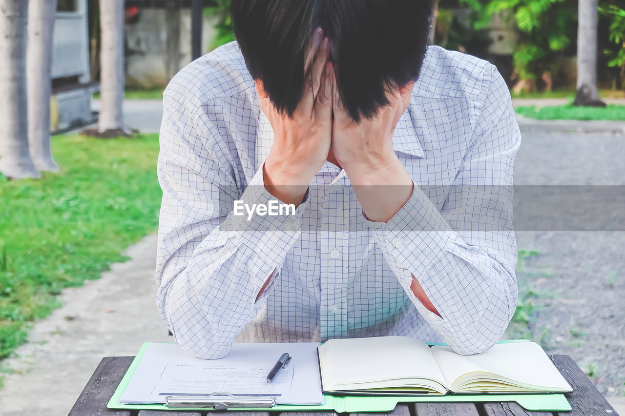 Freelancer with head in hands at table