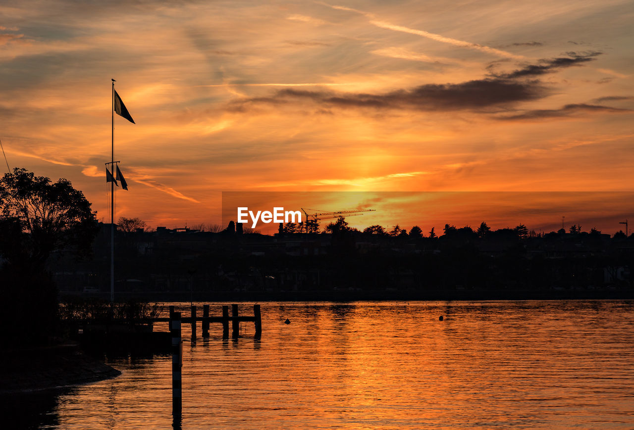 Scenic view of river against orange sky