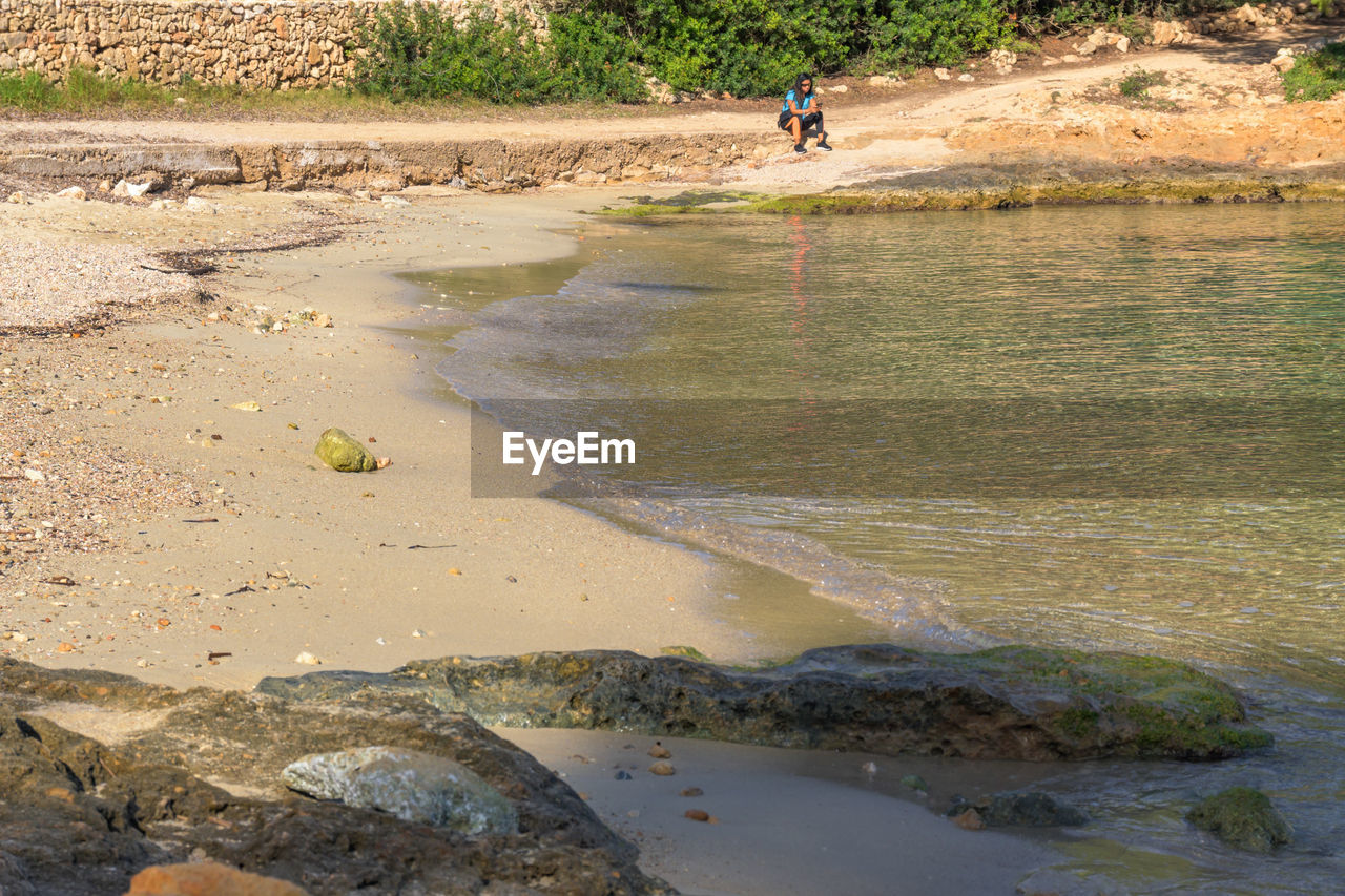 water, nature, land, shore, river, beach, body of water, day, environment, men, coast, outdoors, plant, full length, leisure activity, beauty in nature, soil, sand, one person, lifestyles, animal, dirt, landscape, sunlight, rock, activity, scenics - nature