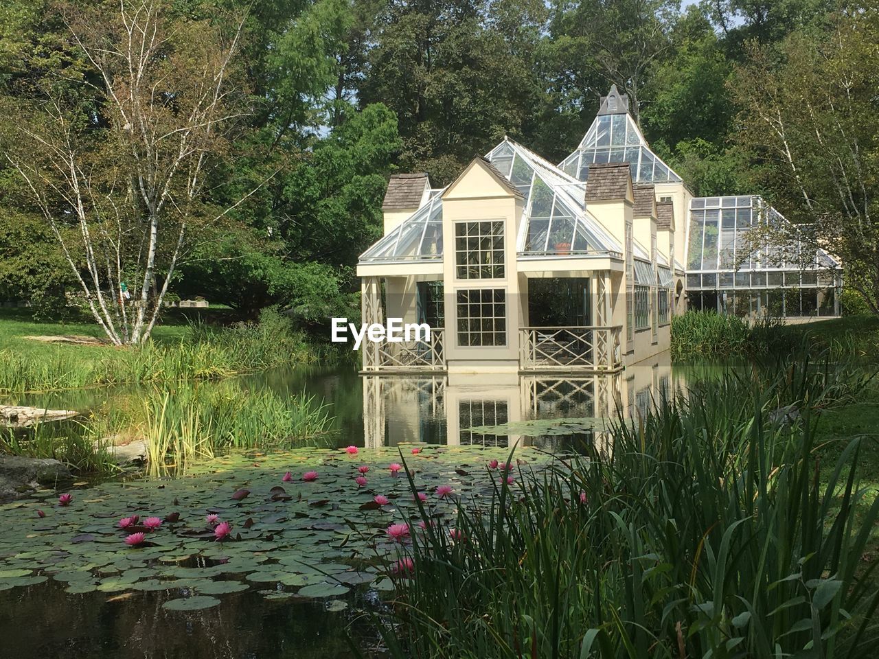 House by lake against building