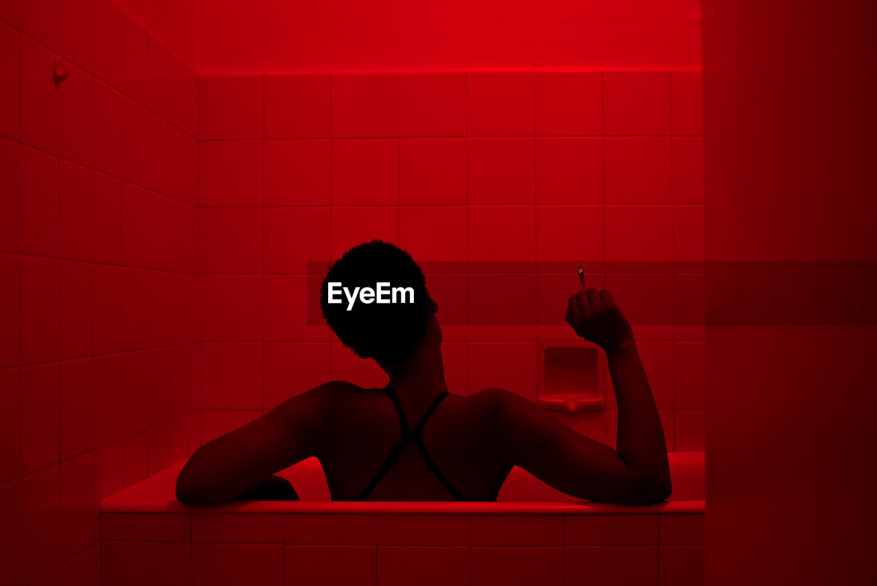 Rear view of woman in bathtub
