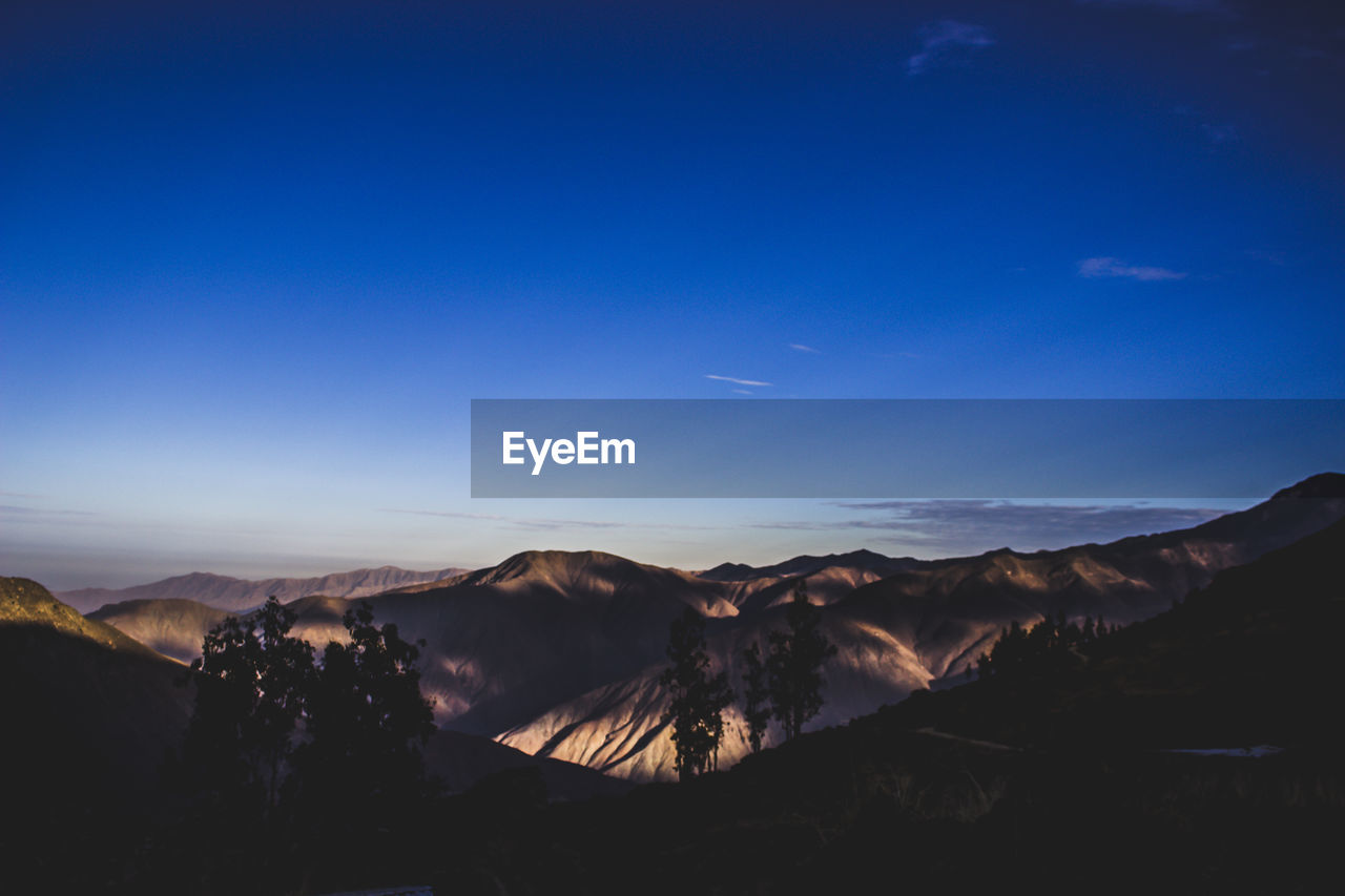 Scenic view of mountains against sky during sunset