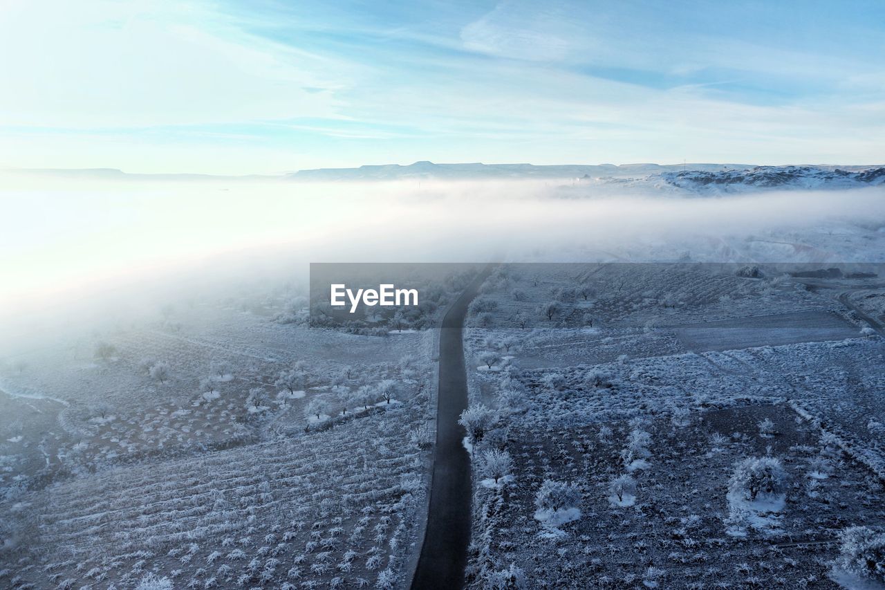 Aerial view of frozen landscape against sky