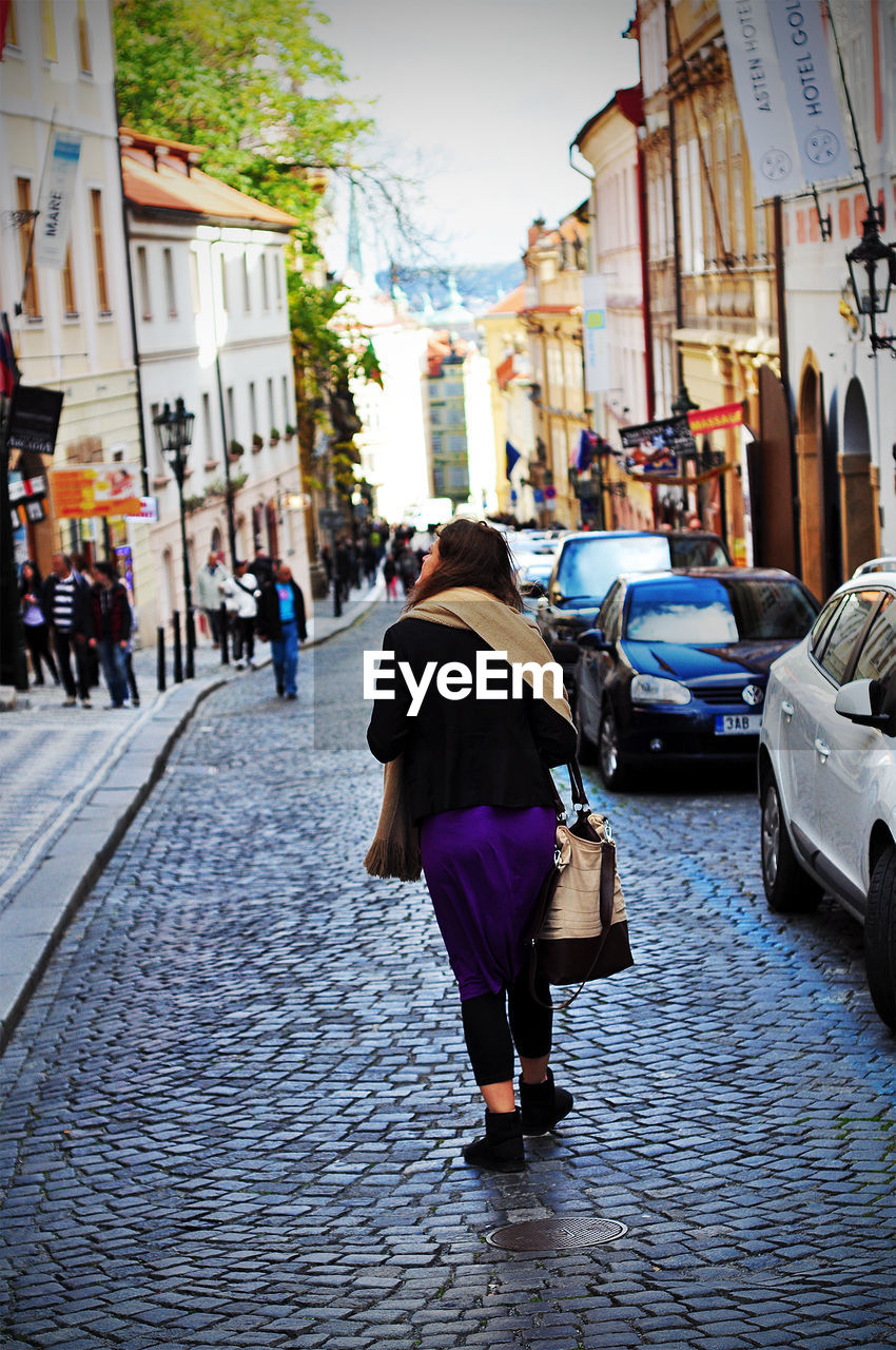 Rear view of woman walking on street