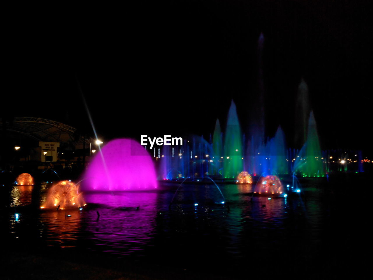 VIEW OF ILLUMINATED CITY AT NIGHT