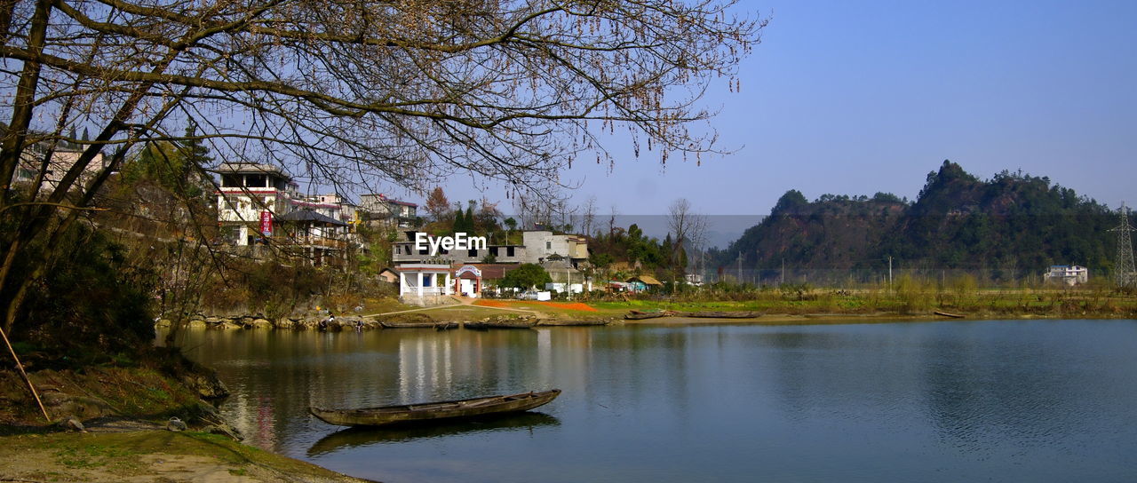 SCENIC VIEW OF HOUSE BY TREES AGAINST CLEAR SKY