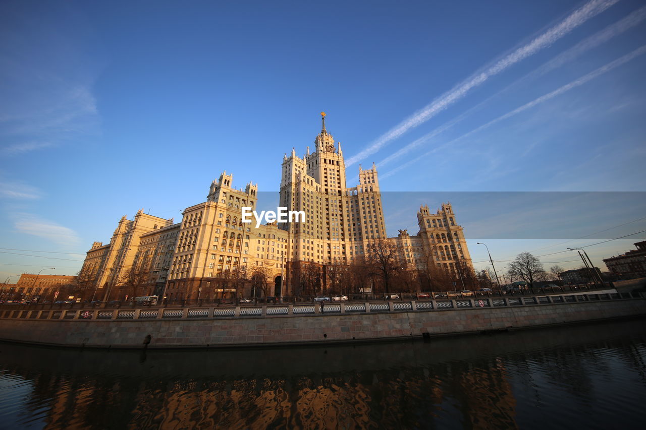 River amidst buildings against sky in city