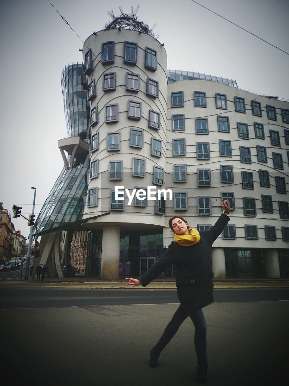 FULL LENGTH OF MAN STANDING IN FRONT OF BUILDING