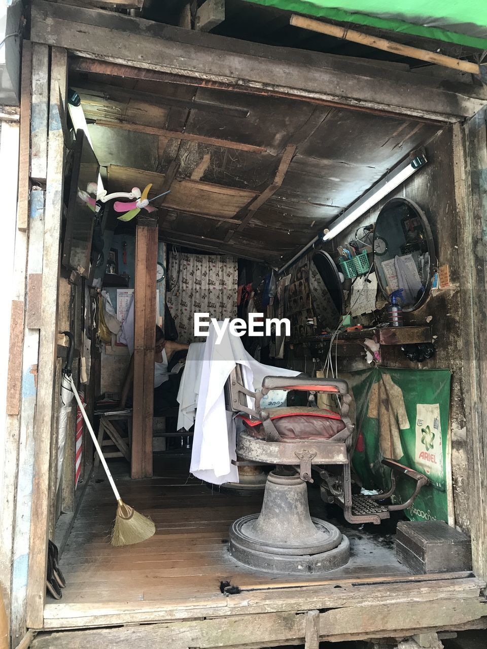 OLD ELECTRIC LAMP HANGING ON WOODEN STRUCTURE