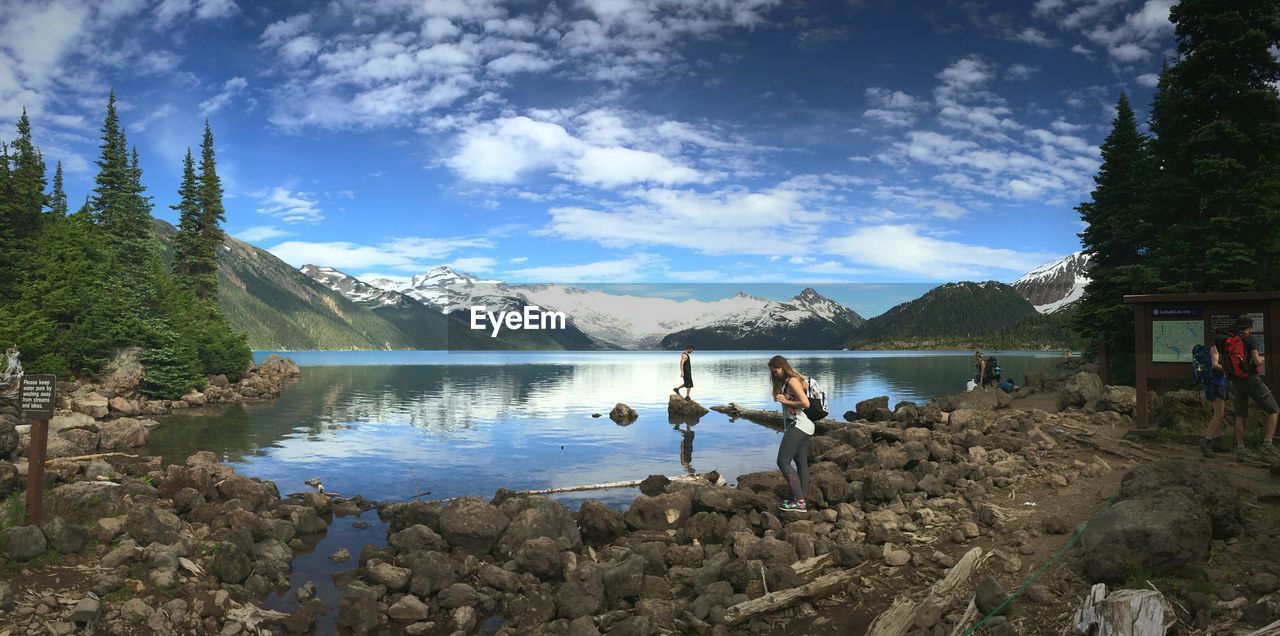 PANORAMIC VIEW OF LAKE AGAINST CLOUDY SKY