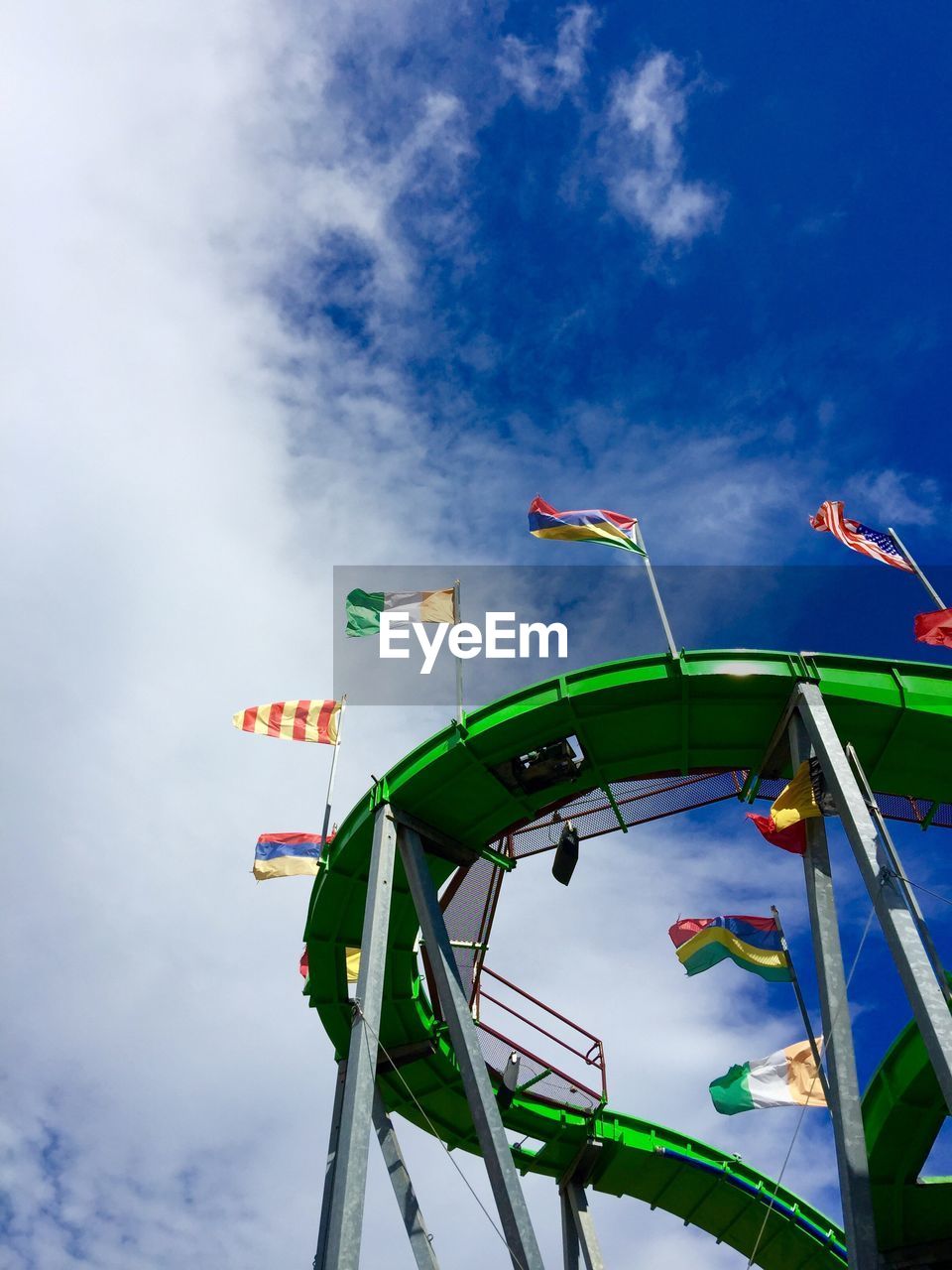 Low angle view of flags on rollercoaster track