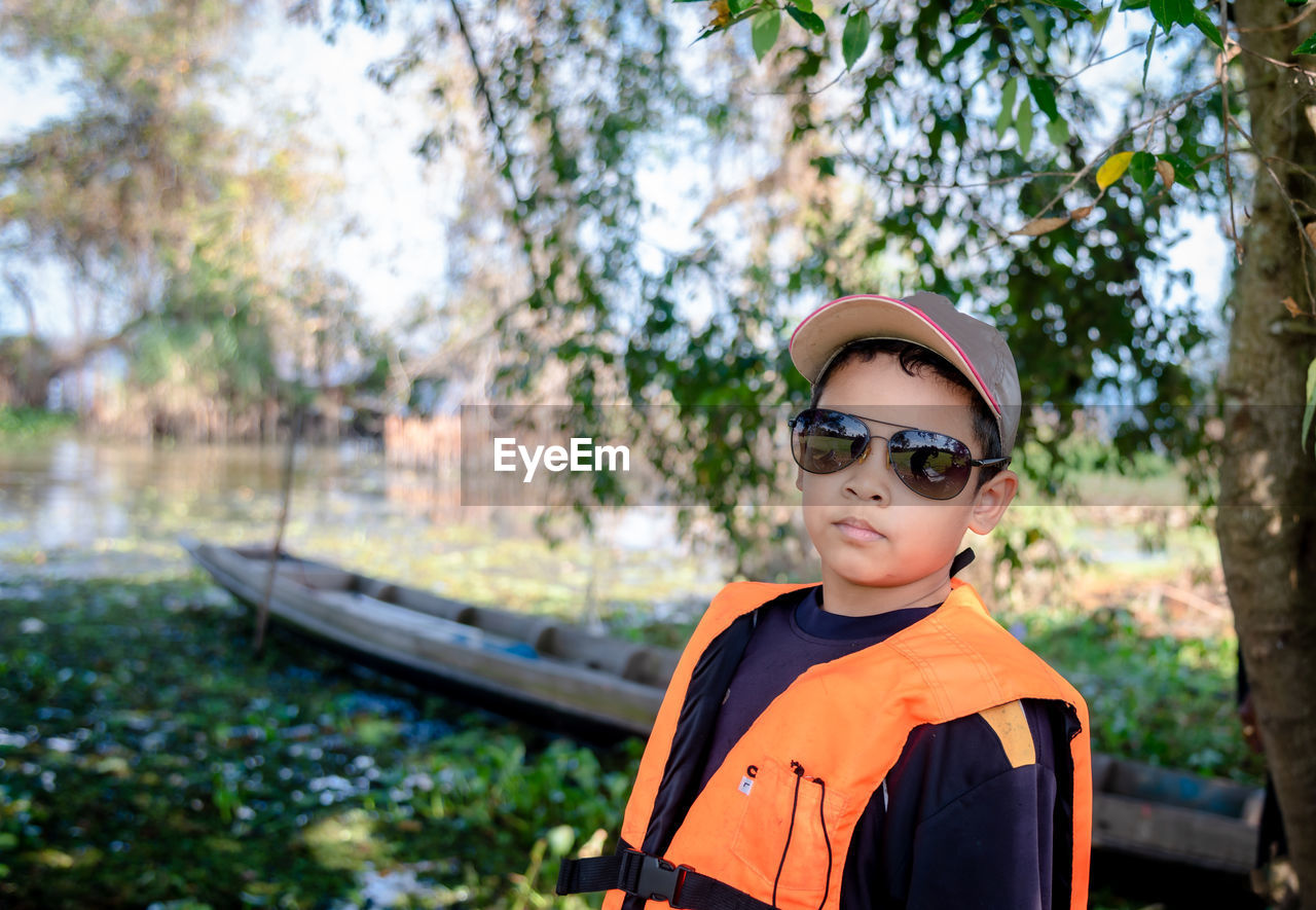 Asian tourists boy wear life jackets and are ready to travel abroad.