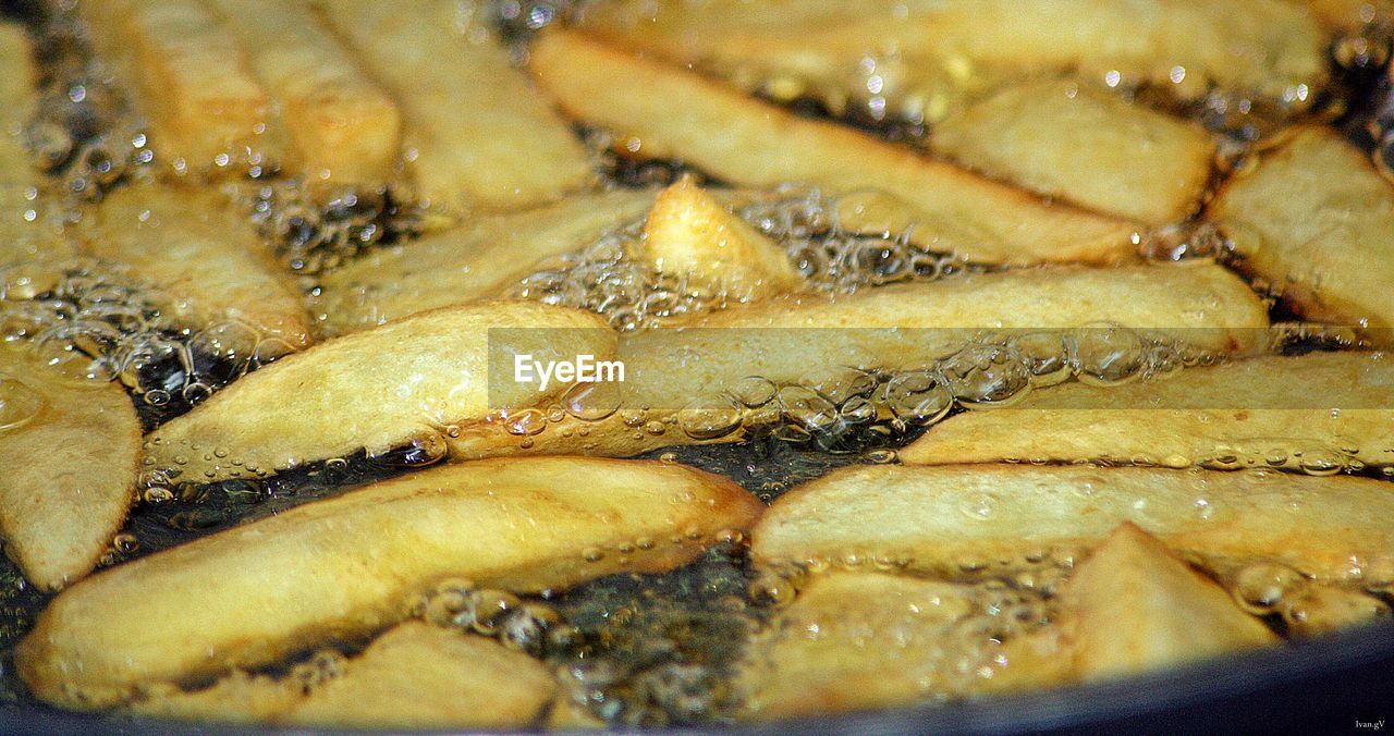 Close-up of frying potato chips