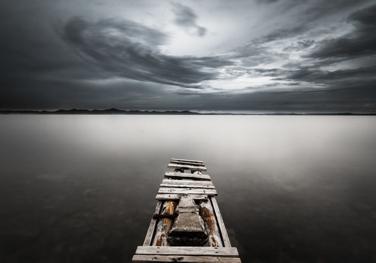 Abandoned pier at calm sea