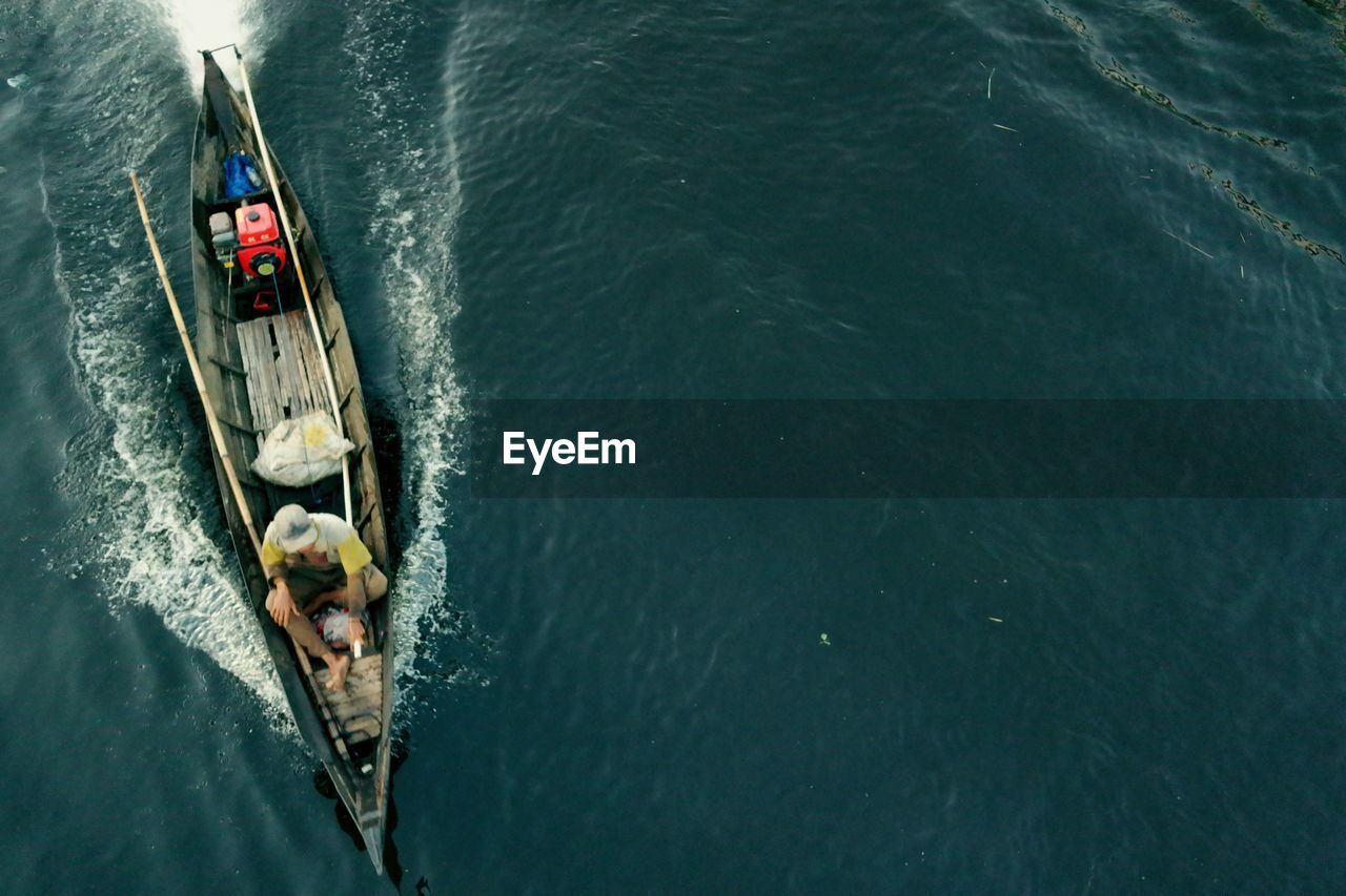 Directly above shot of man on boat sailing in sea 