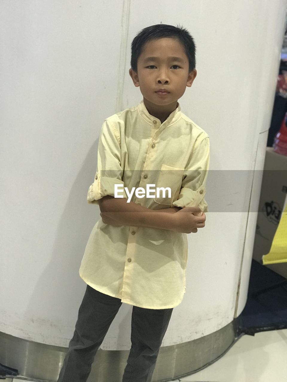 PORTRAIT OF BOY STANDING AGAINST WALL