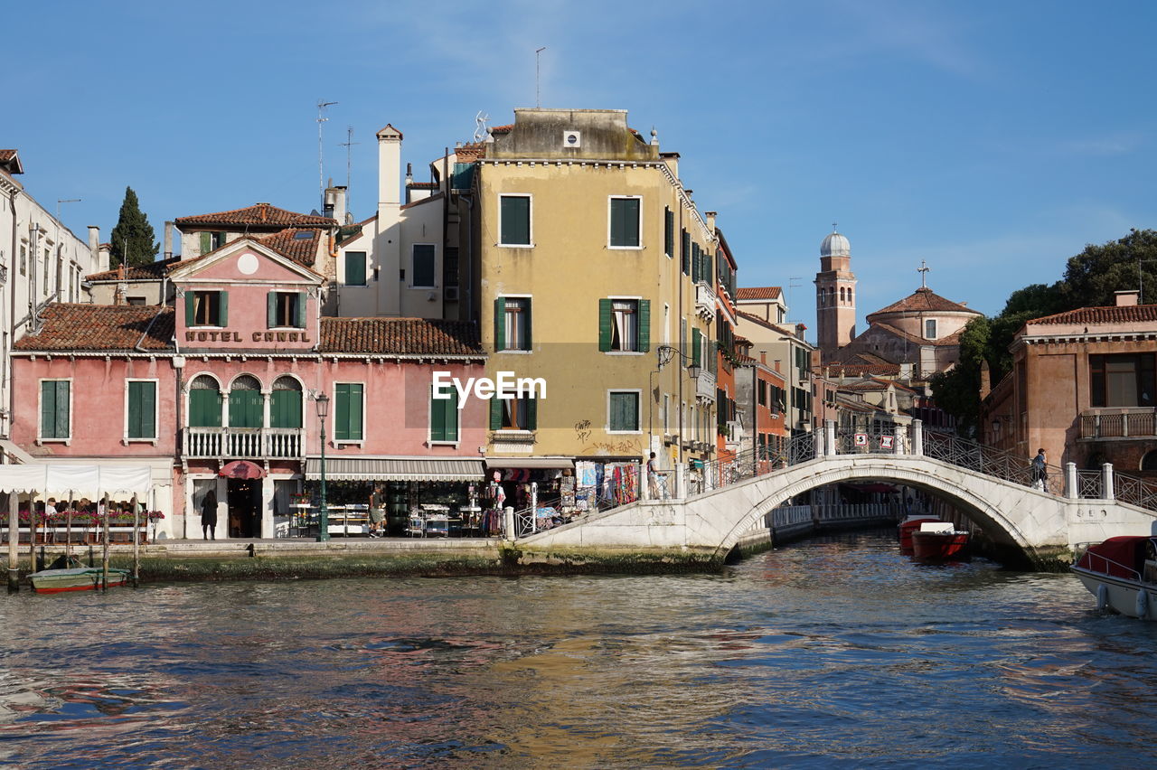 Arch bridge over grand canal in city against sky