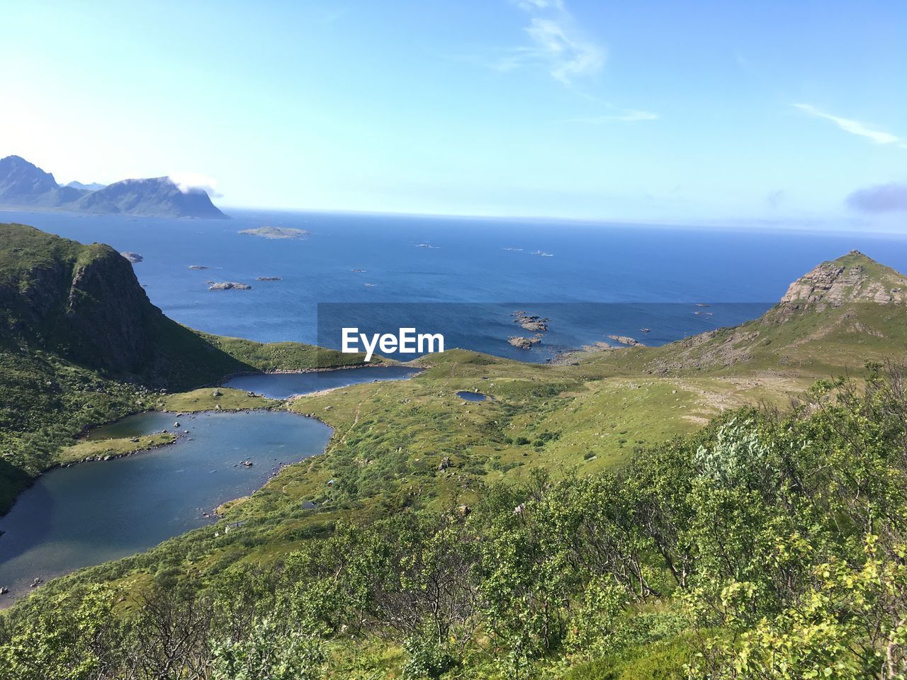 Scenic view of sea and mountains against sky