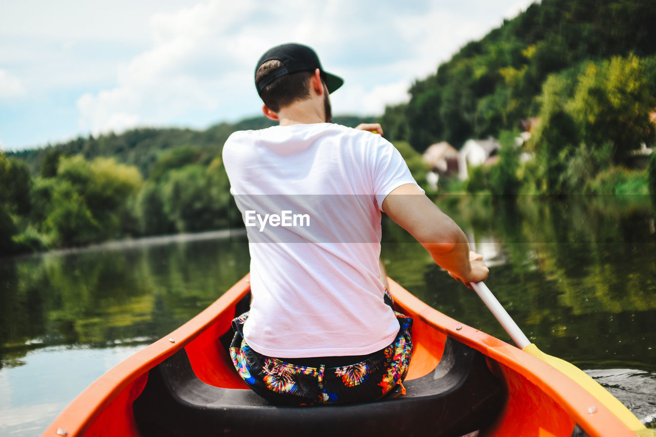 REAR VIEW OF MAN IN LAKE