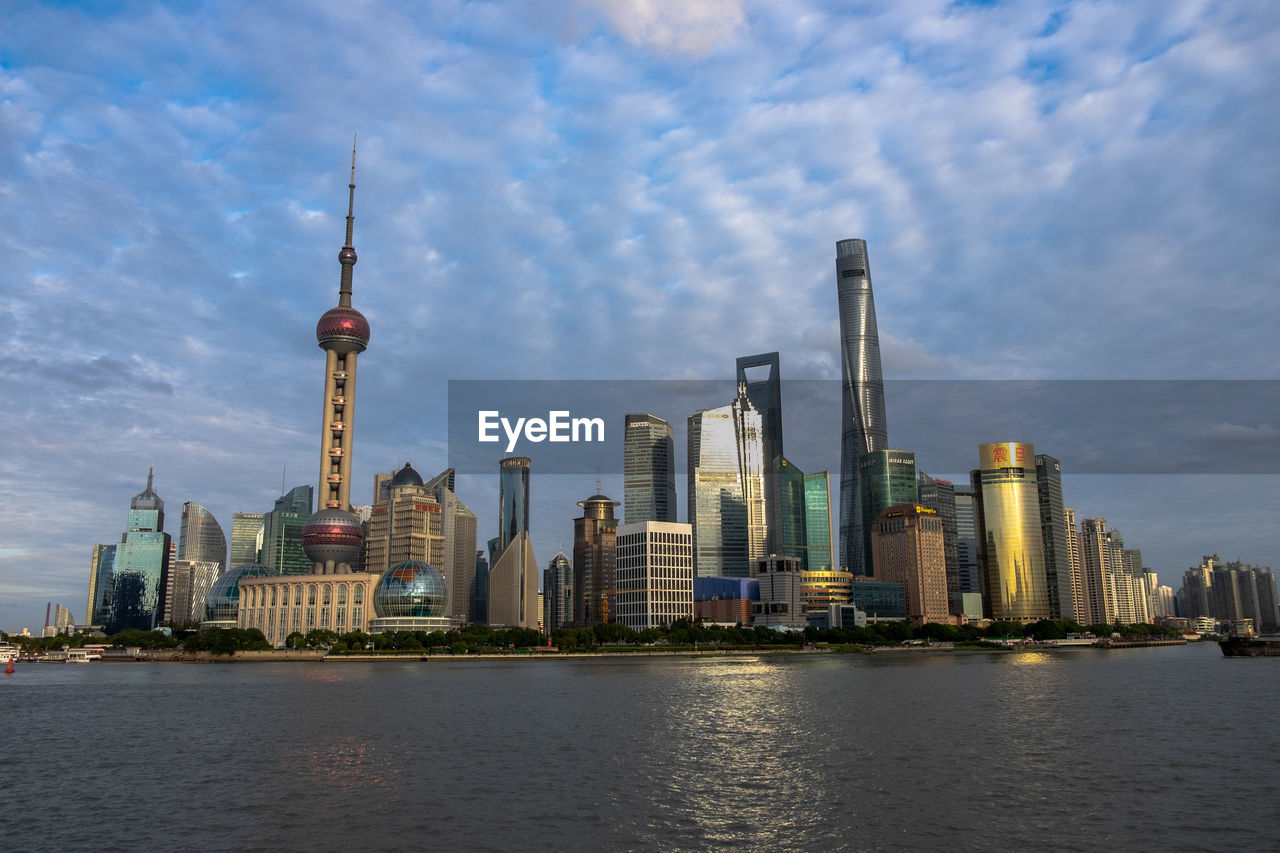 CITY BUILDINGS AGAINST CLOUDY SKY