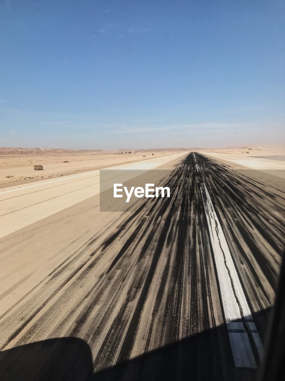 Scenic view of desert against clear blue sky