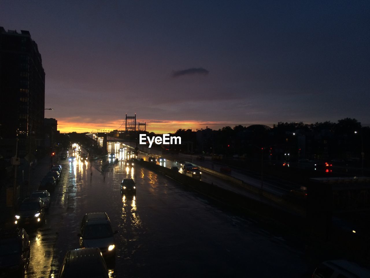 ILLUMINATED CITYSCAPE AGAINST SKY AT SUNSET