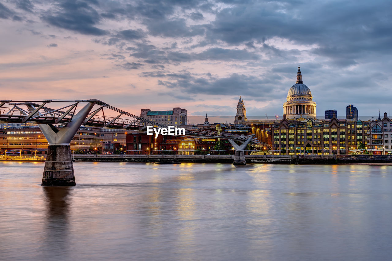 Bridge over river with buildings in background