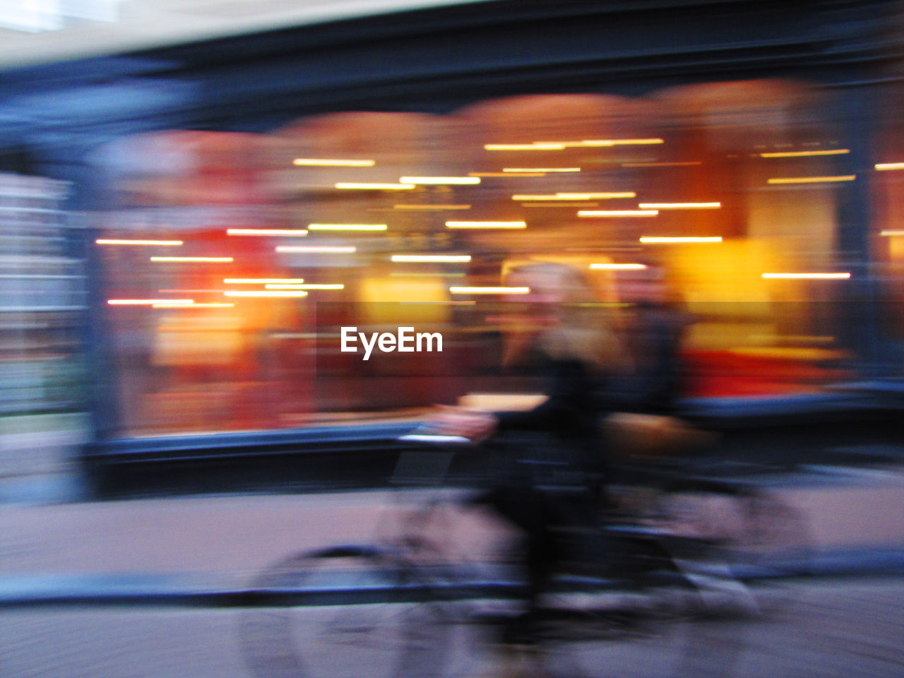 BLURRED MOTION OF CAR ON ILLUMINATED RAILROAD STATION