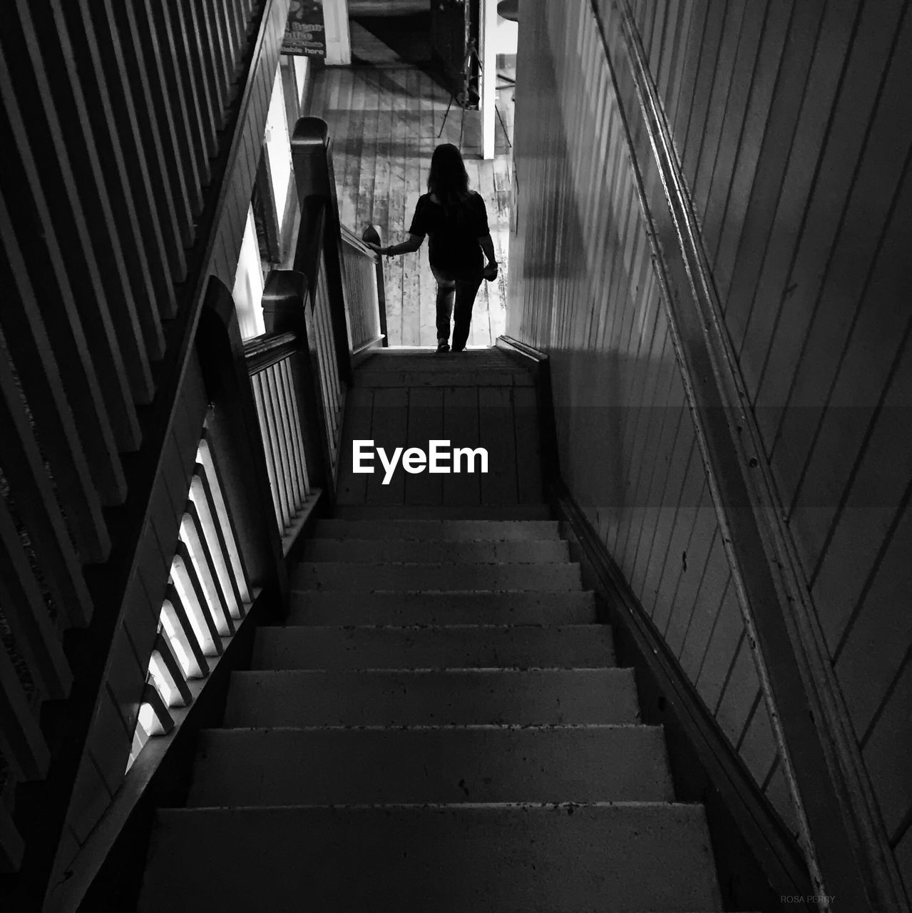 Rear view of woman on stairway