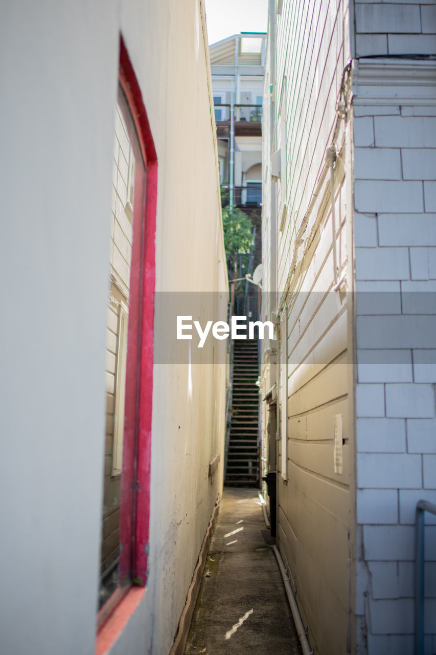 Empty alley amidst buildings in city