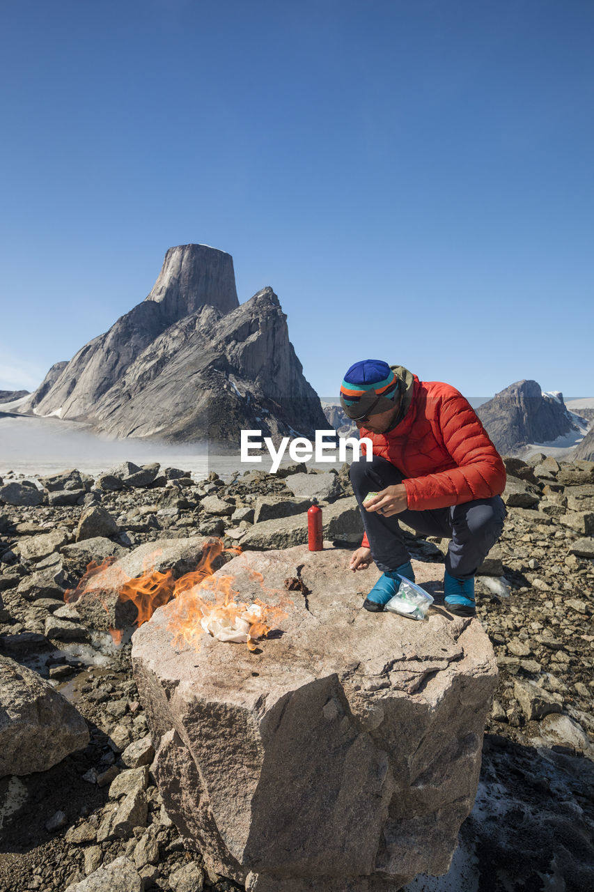 Mountaineer bunrs toilet paper to leave no trace in the backcountry.