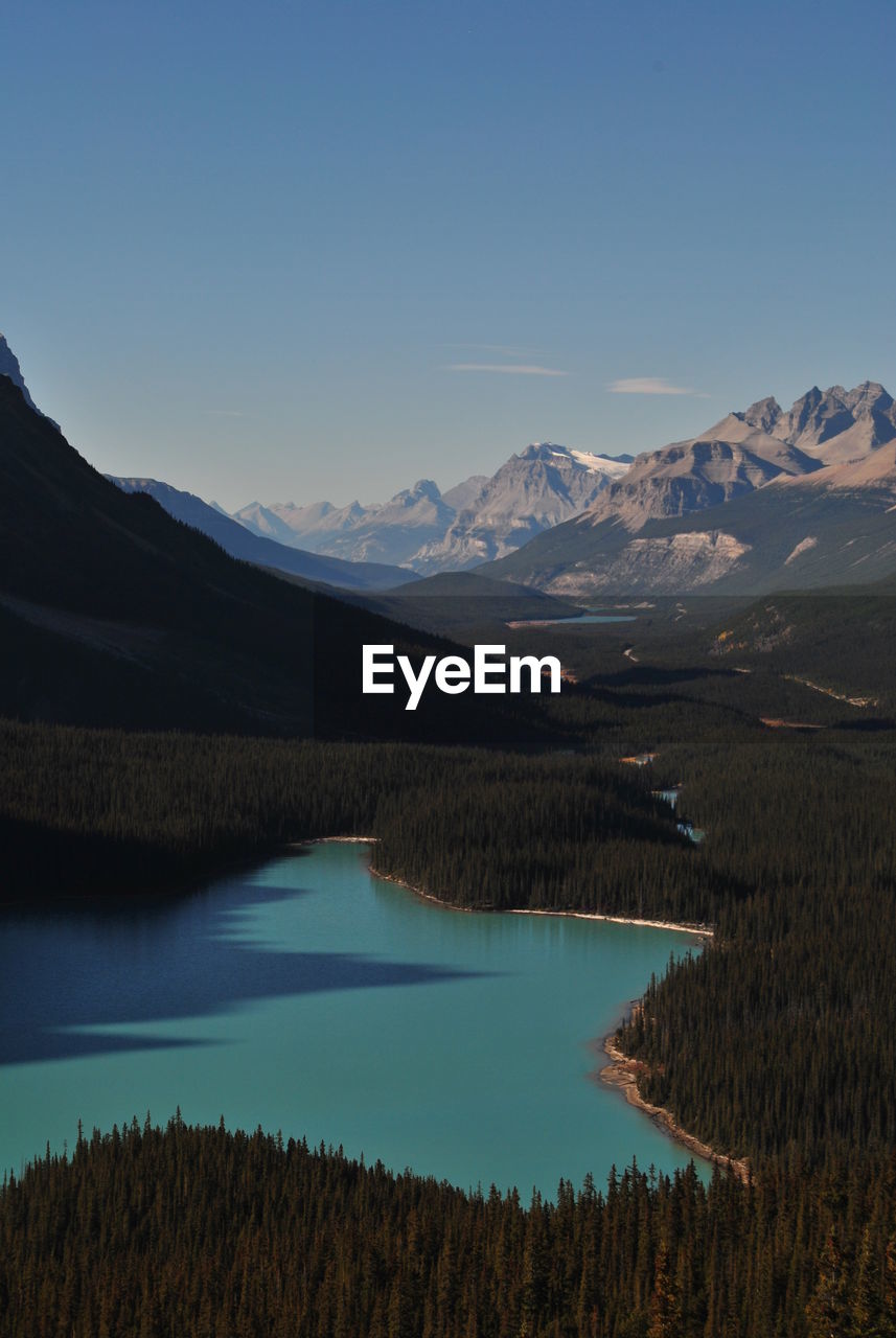 Scenic view of lake and mountains against blue sky