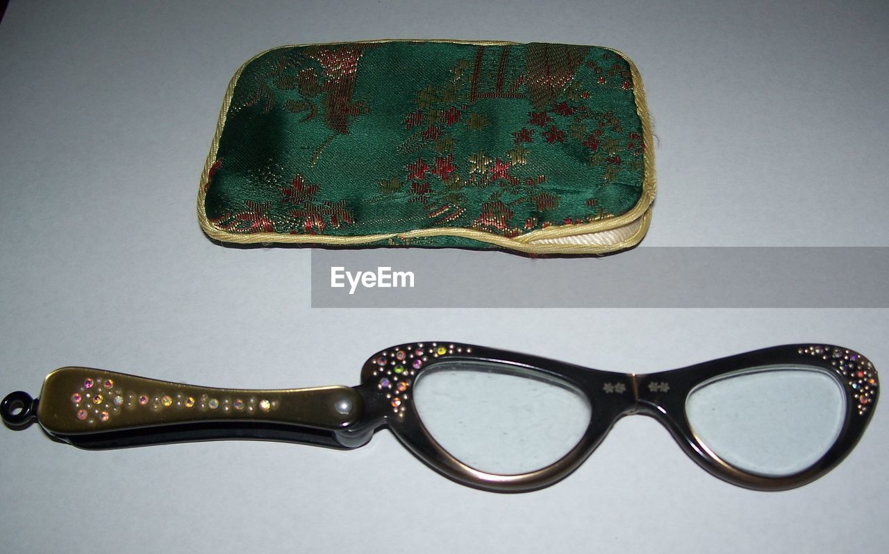 CLOSE-UP OF EYEGLASSES ON TABLE