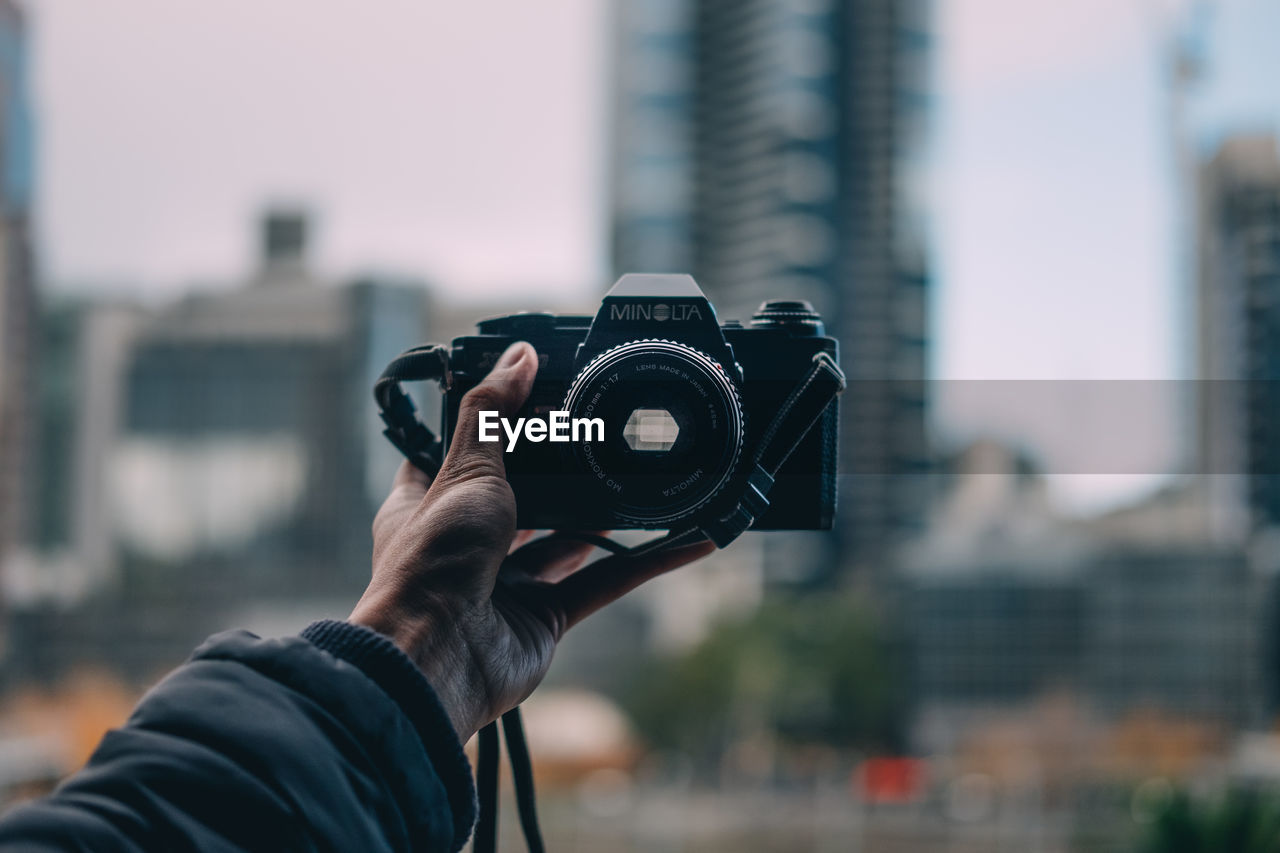 CROPPED IMAGE OF PHOTOGRAPHER PHOTOGRAPHING