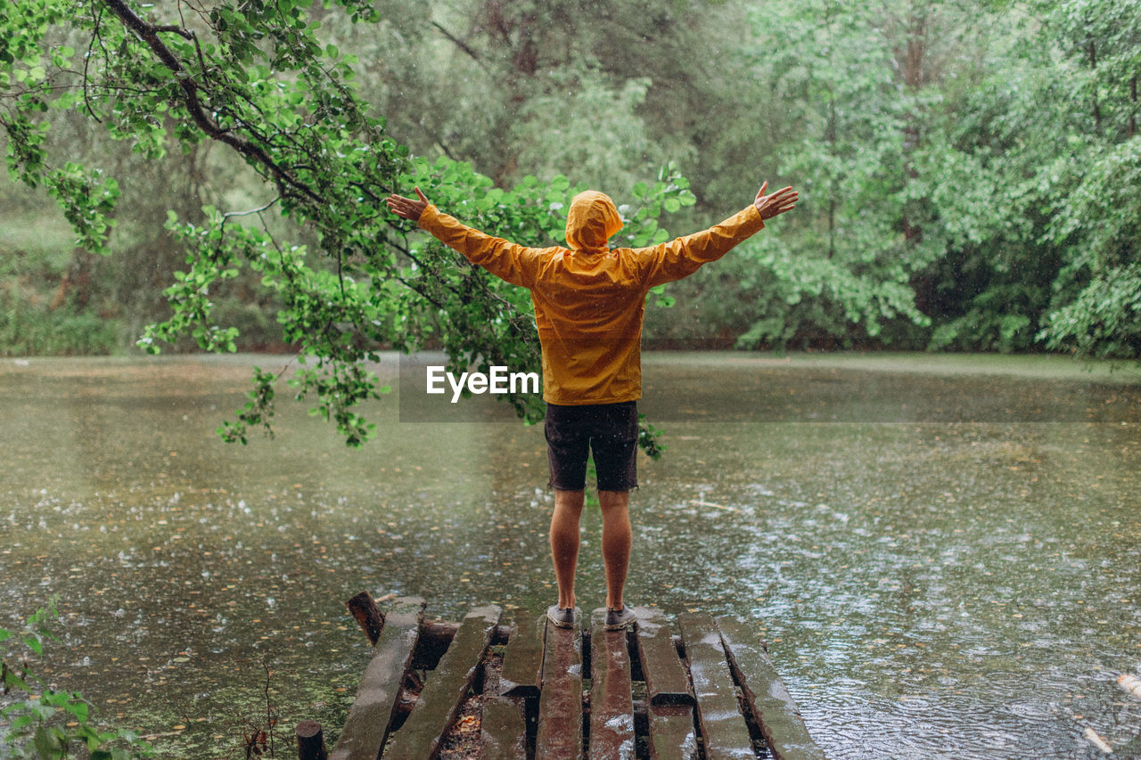 Full length of man standing by lake