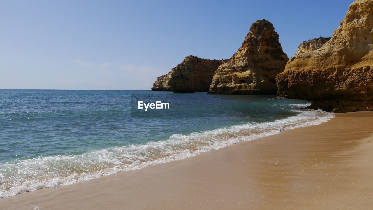 Typical shore of algarve, portugal wirh beautiful sandy beach and rock formation