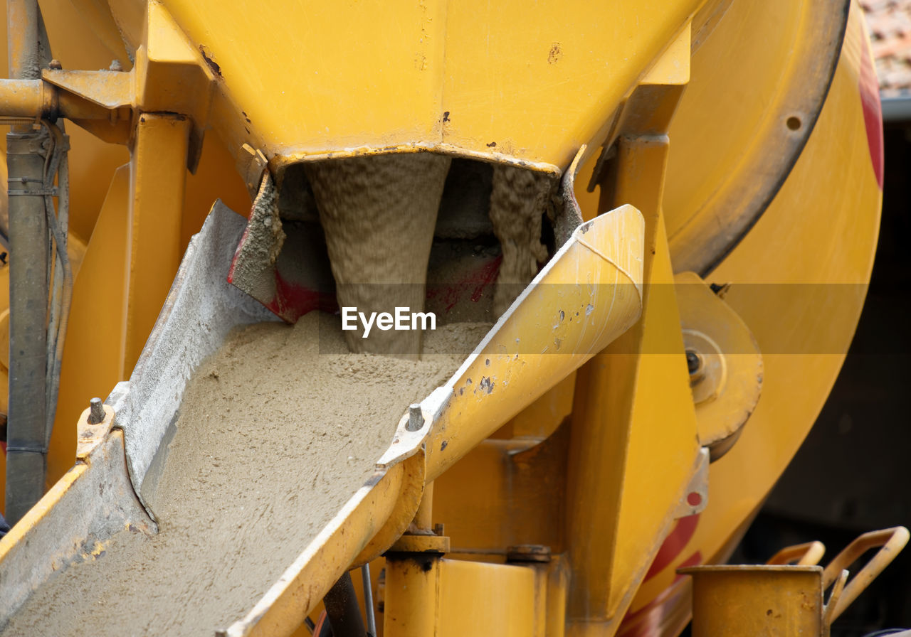 Liquid soil is poured from the ramp of concrete mixer