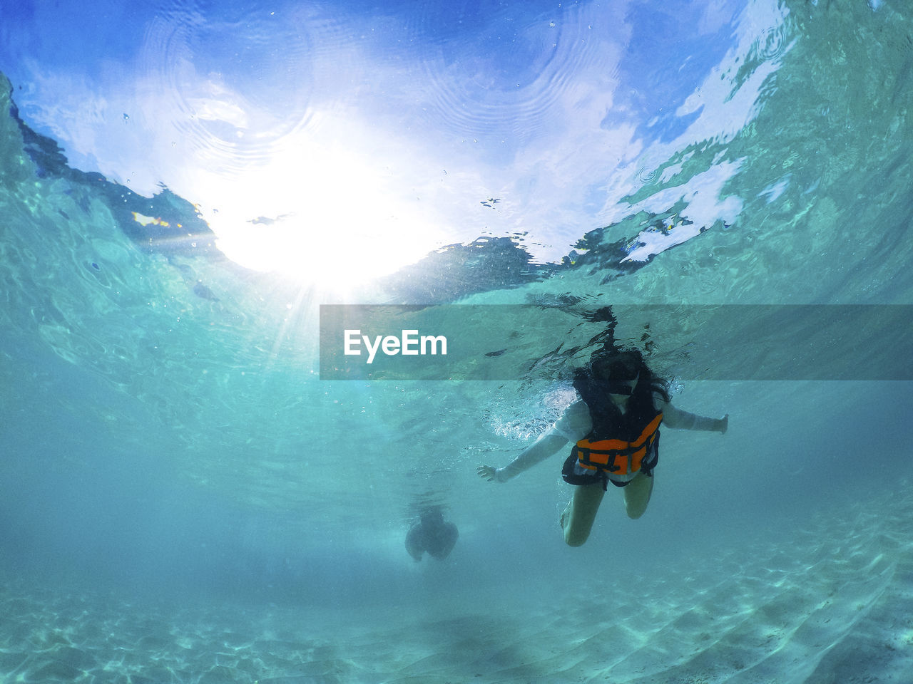 Low angle view of girl swimming undersea