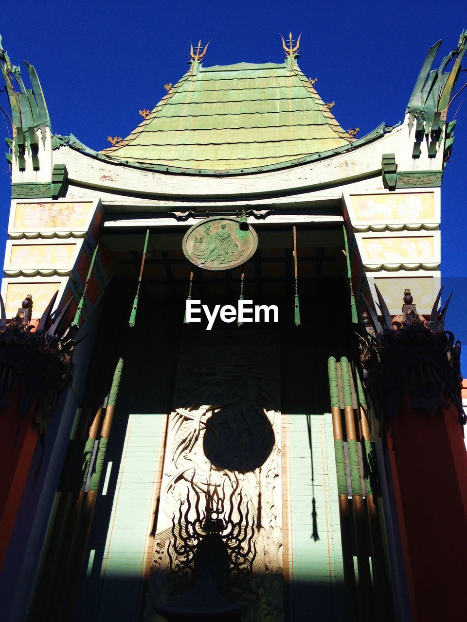 Low angle view of tcl chinese theatre against blue sky