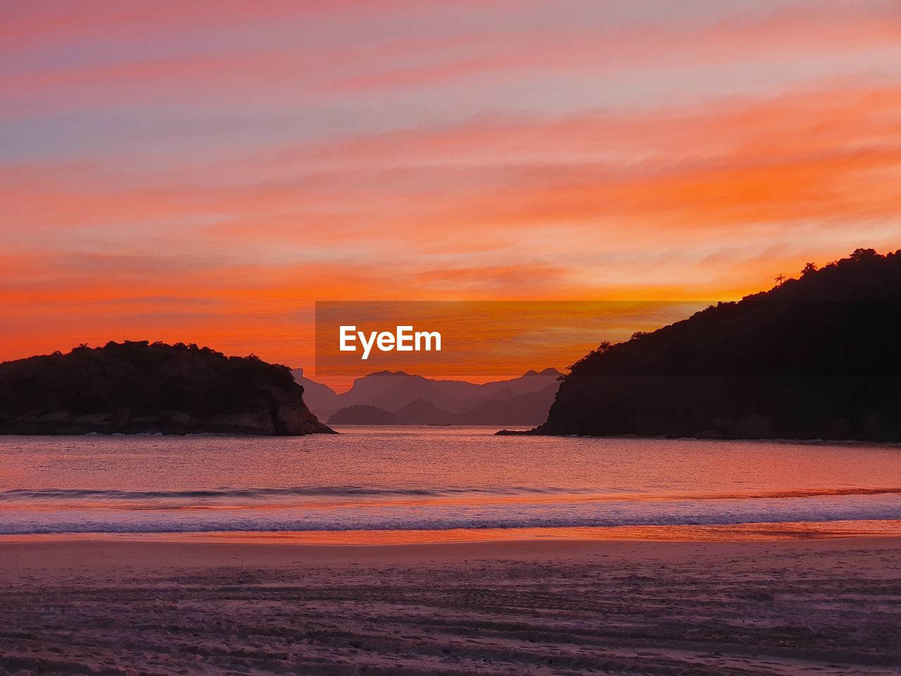 Scenic view of silhouette mountains against sky during sunset