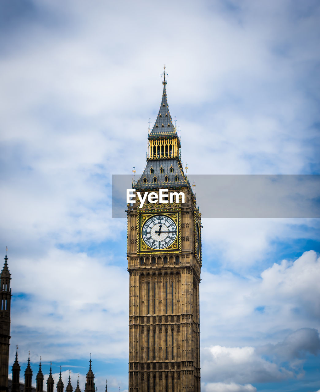 Low angle view of clock tower against cloudy sky