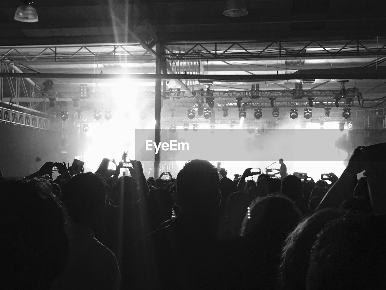 People photographing at music concert