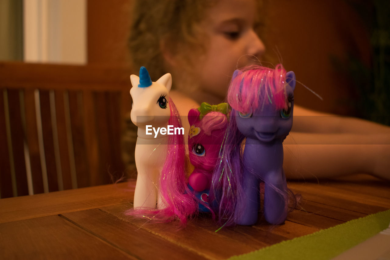 CLOSE-UP OF BABY ON TABLE WITH INDOORS