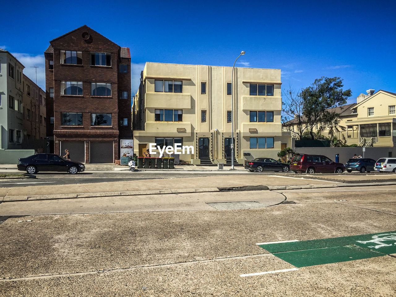 Empty road along buildings