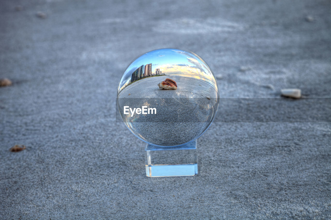 Seashell through a crystal ball on north naples beach at sunrise in naples, florida