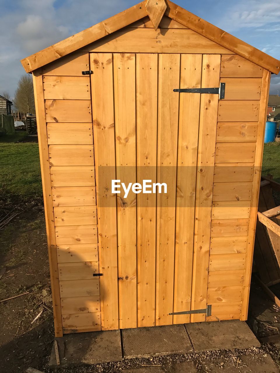 Closed wooden door of new shed