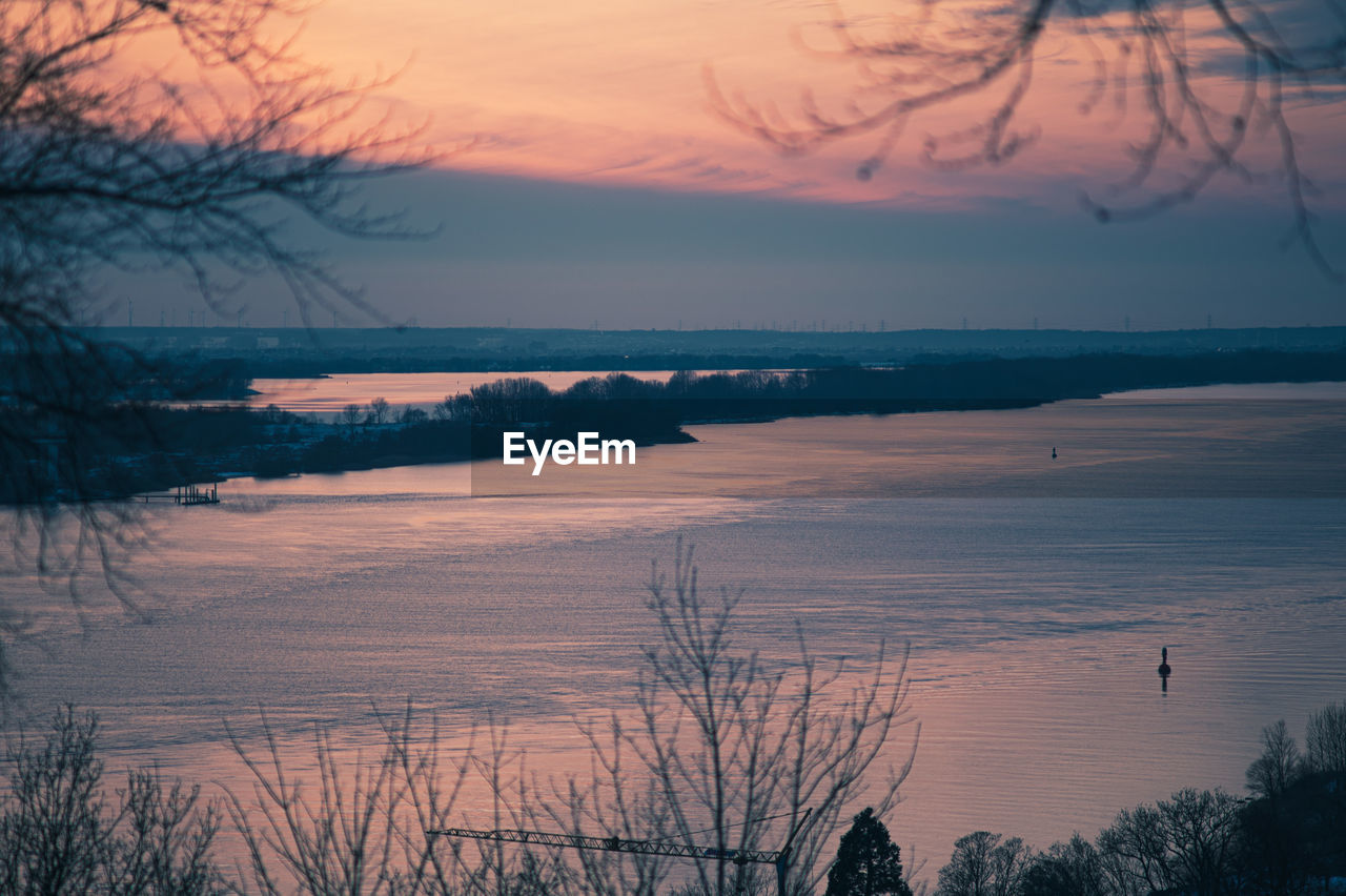 scenic view of beach against sky during sunset