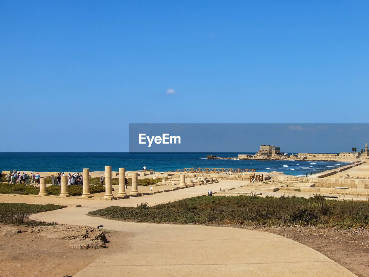 Caesarea maritima by sea against sky on sunny day
