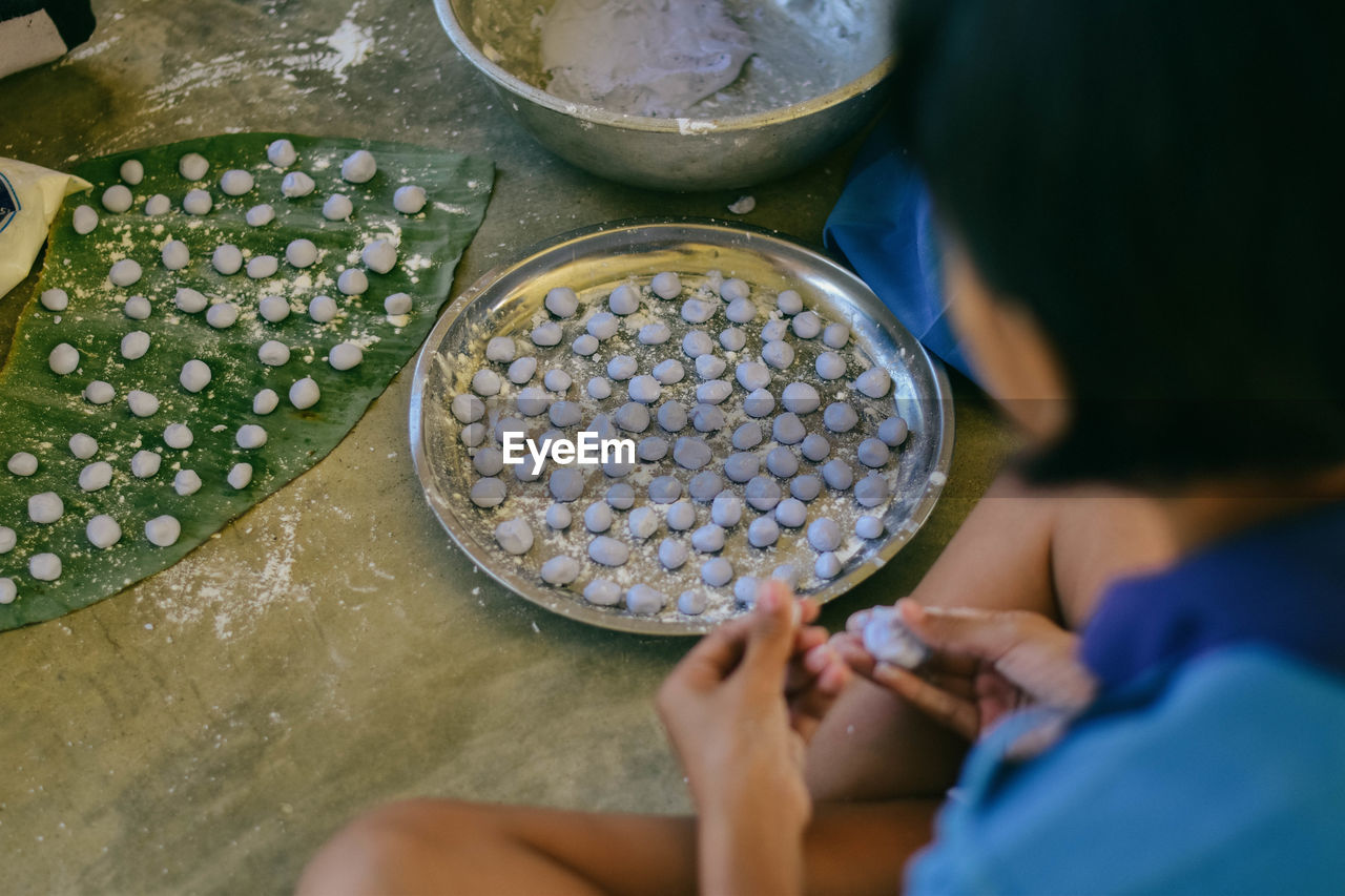 Close-up of girl making food in kitchen